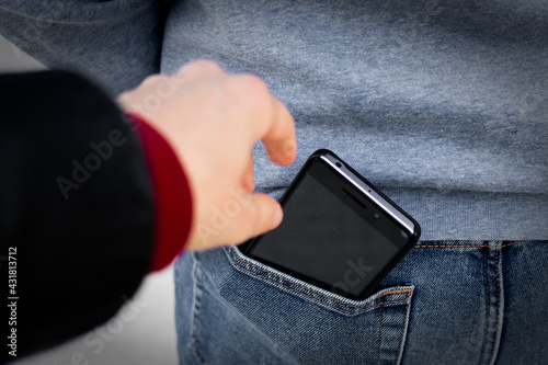 Foto stealing smart phone from back pocket, Pickpocket