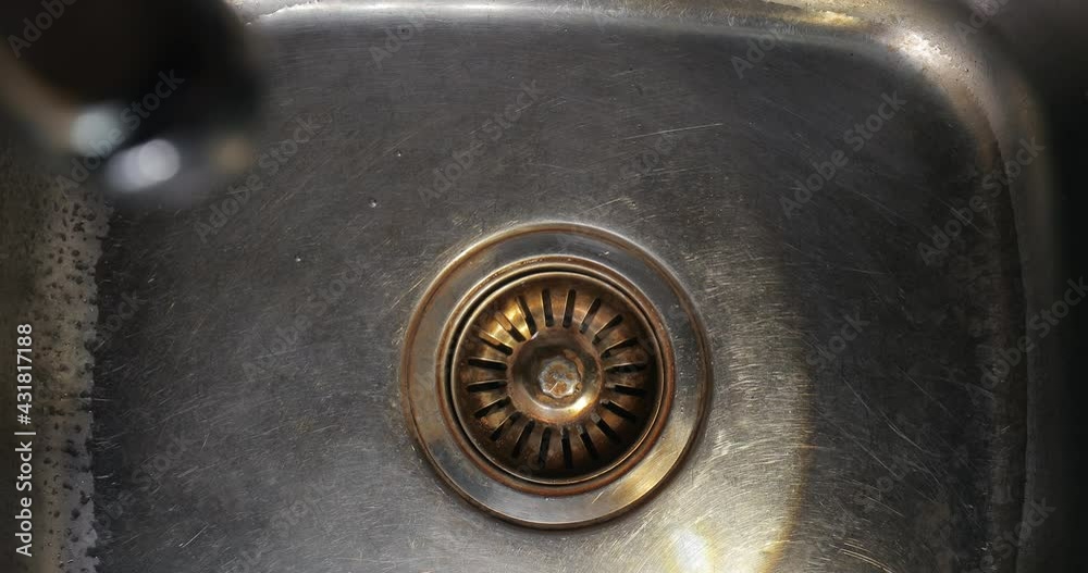 Kitchen sink filled with water being drained Kitchen sink filled with water being drained
