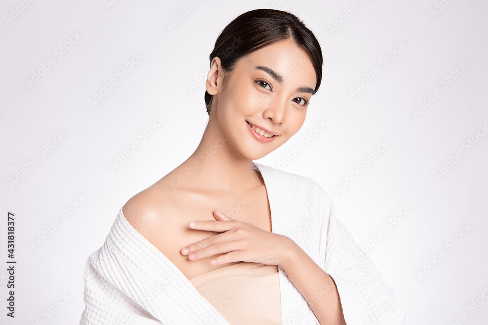 Beautiful young Asian woman wearing bathrobe on white background, Face care, Facial treatment, Cosmetology, beauty and spa Concept. Beautiful young Asian woman wearing bathrobe on white background, Face care, Facial treatment, Cosmetology, beauty and spa Concept.