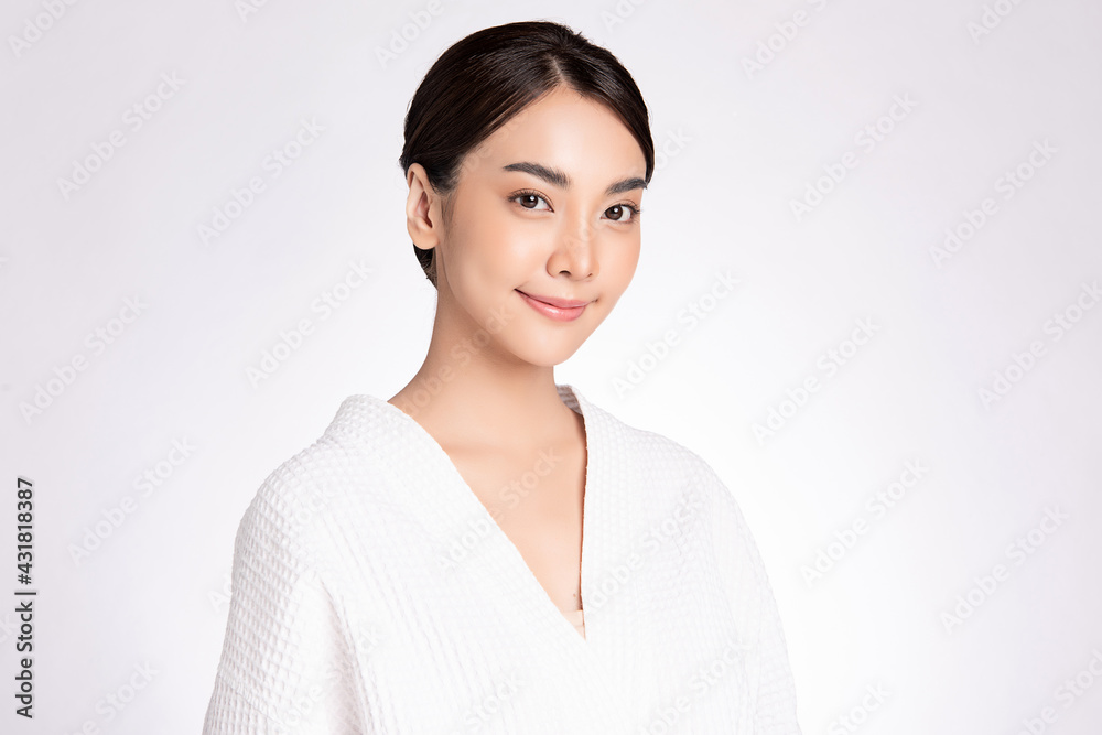 Beautiful young Asian woman wearing bathrobe on white background, Face care, Facial treatment, Cosmetology, beauty and spa Concept. Beautiful young Asian woman wearing bathrobe on white background, Face care, Facial treatment, Cosmetology, beauty and spa Concept.