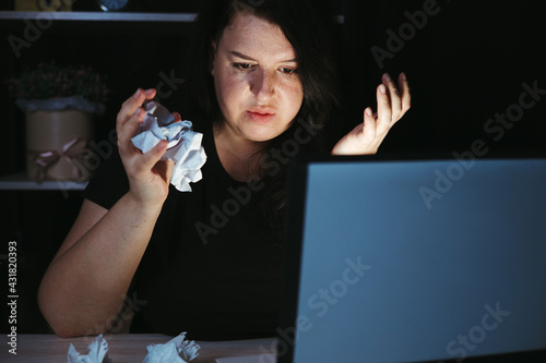 Tired exhausted woman working with laptop at night photo