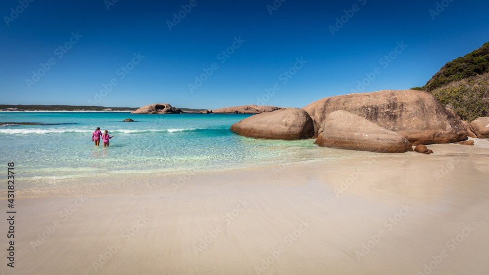 Landscape view of the pristine white sands, crystal clear aqua water and granite boulders on a clear blue day at Twilight Cove, near Esperance in Western Australia.