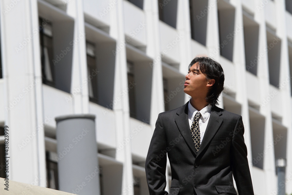 Young Japanese businessman walking in the american business district
Young Japanese businessman walking in the american business district