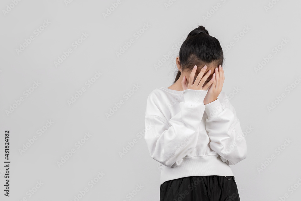 Cute little girl on gray background covering eyes with hands and doing stop gesture with sad and fear expression. Embarrassed and negative Cute little girl on gray background covering eyes with hands and doing stop gesture with sad and fear expression. Embarrassed and negative