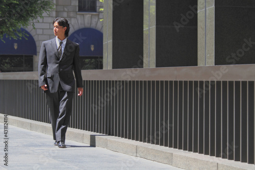 Young Japanese businessman walking in the american business district © funbox