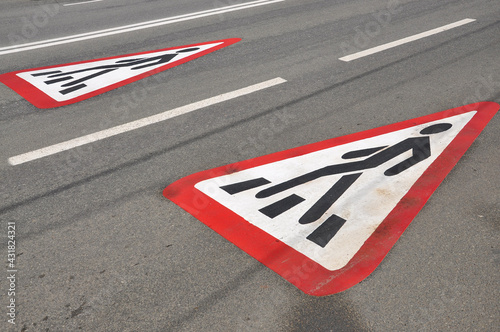 warning sign of a pedestrian crossing on the road. road signs. © Konstantin Ivshin