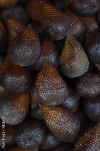 A collection of ripe zalacca fruits that are on display at the market.