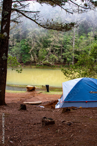 blue tent camping by the lake