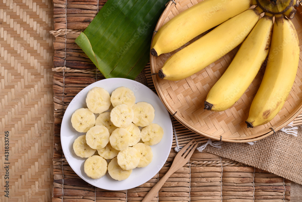 Sliced banana fruit on white dish with fork ready to eating, Tropical fruit Sliced banana fruit on white dish with fork ready to eating, Tropical fruit