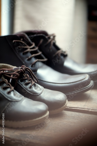 selective focus child boots and adult boots