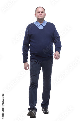 mature man in blue jumper striding forward.