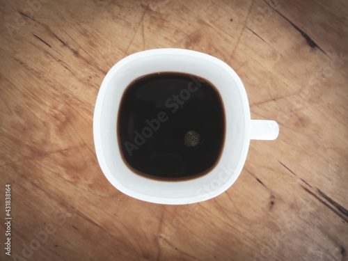 Black coffee in a white cup close-up.