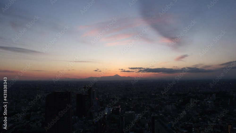 TOKYO, JAPAN : Aerial high angle sunset or sunrise CITYSCAPE of TOKYO. View of buildings around Shibuya. Japanese city life and nature concept. Colorful gradation sky. Real time shot. TOKYO, JAPAN : Aerial high angle sunset or sunrise CITYSCAPE of TOKYO. View of buildings around Shibuya. Japanese city life and nature concept. Colorful gradation sky. Real time shot.
