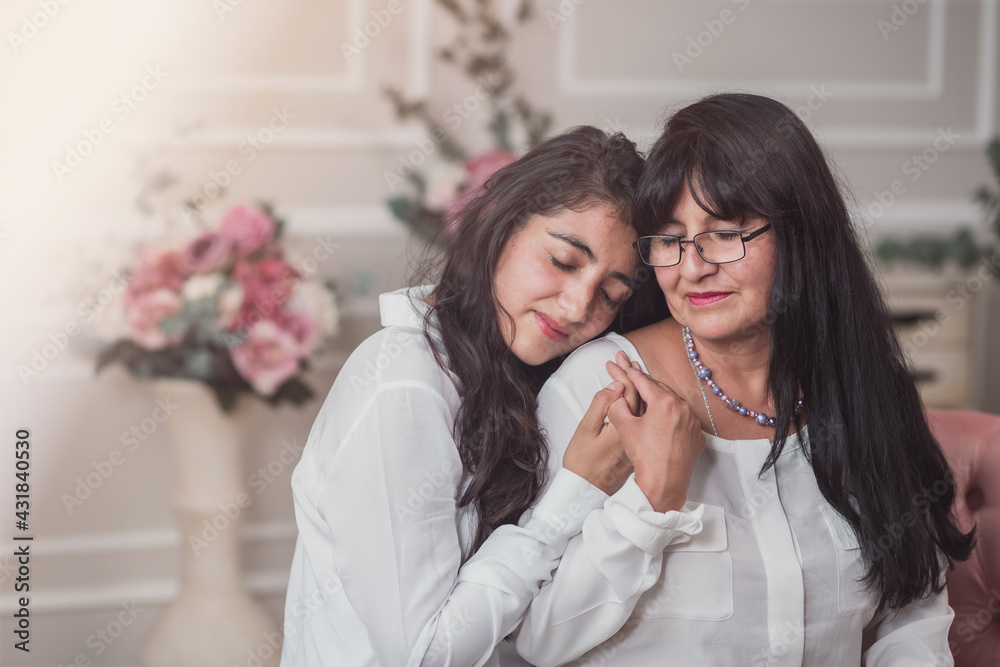 Mexican mother and daughter hugging on mother's day