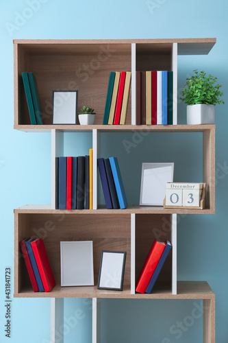 Shelf unit with books near color wall