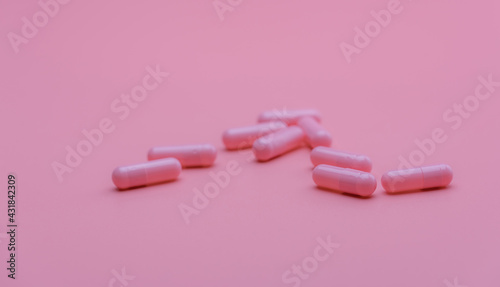 Pink capsules pill on pink background. Vitamins and supplements. Online pharmacy. Pharmacy store banner. Pharmaceutical industry. Woman's health insurance concept. Pills for love and happy life.