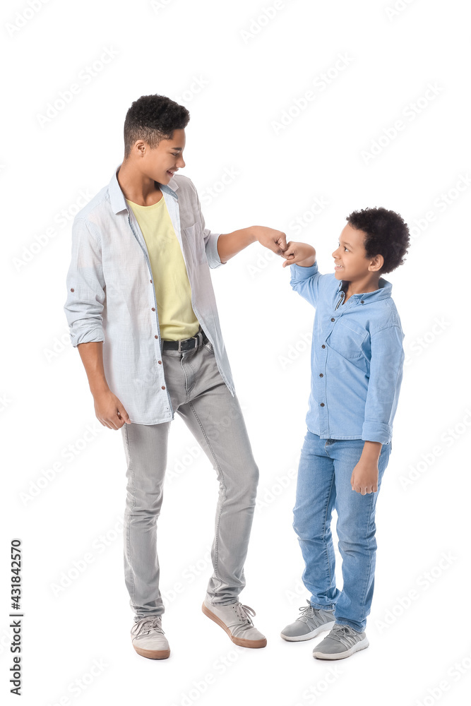 African-American boys bumping fists on white background African-American boys bumping fists on white background