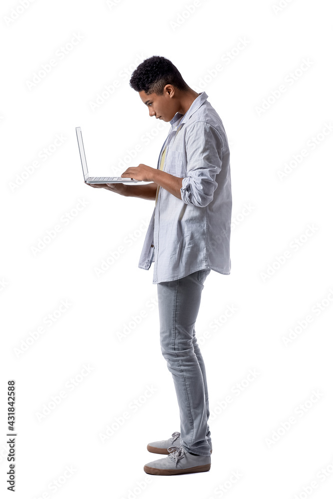 Teenage boy with bad posture using laptop on white background Teenage boy with bad posture using laptop on white background