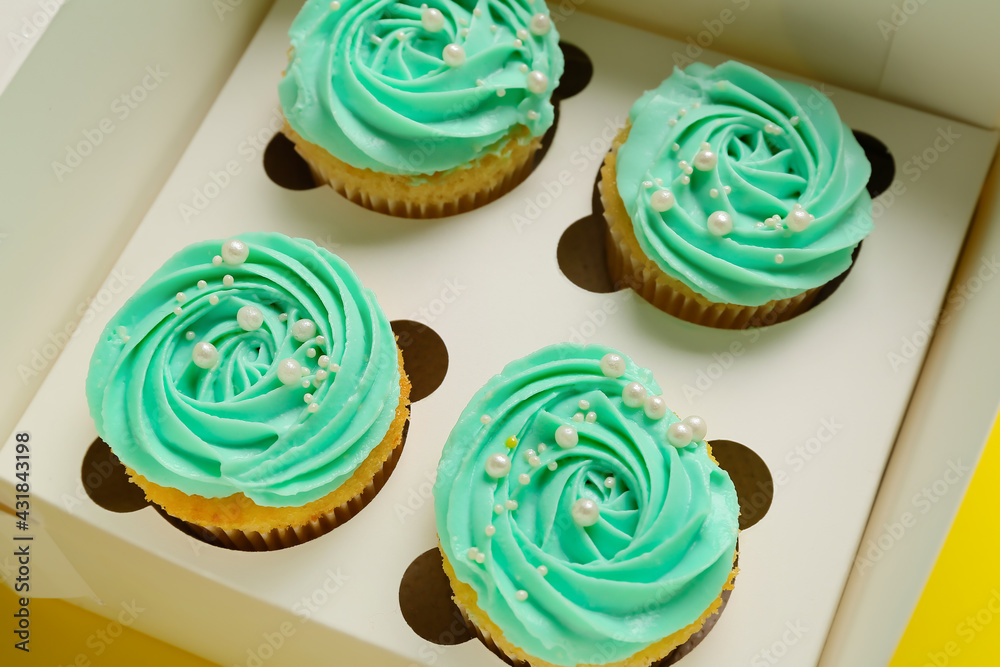 Box with tasty cupcakes, closeup Box with tasty cupcakes, closeup