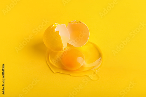 Broken egg on color background