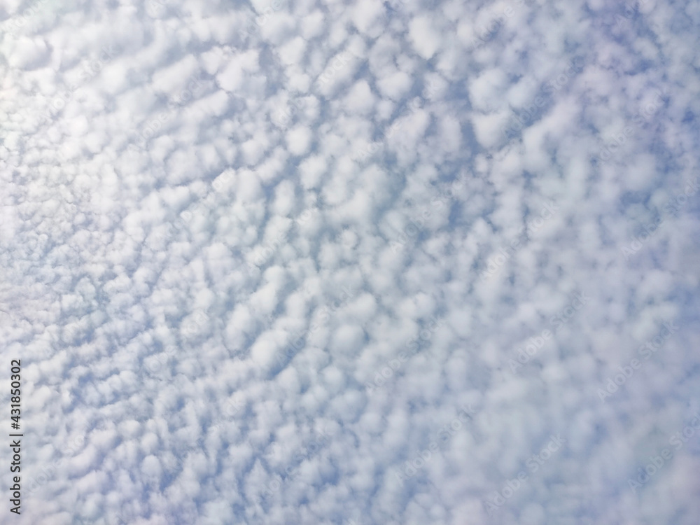 white dappled cloud pattern in blue sky for natural background.