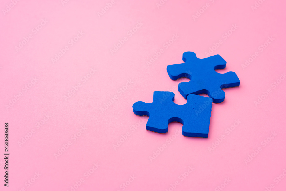 Blue puzzle pieces on paper background top view