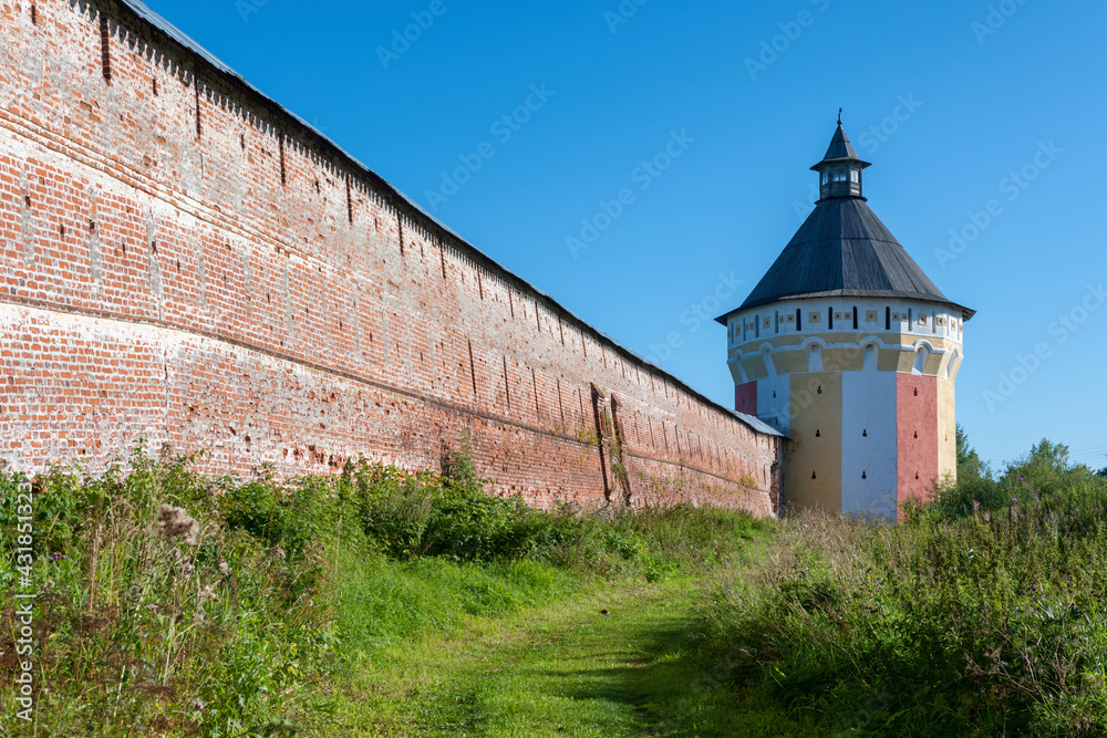Tower and wall of Spaso-Prilutsky Monastery on sunny summer day. Vologda town, Russia.