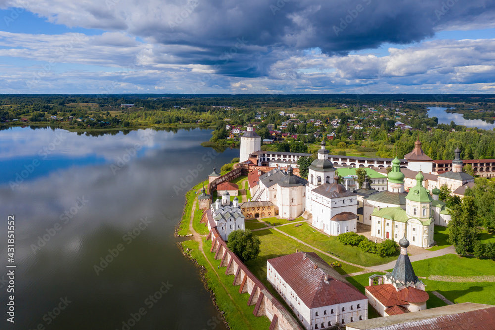 Aerial view of Kirillo-Belozersky Monastery and lake Siverskoye on sunny summer day with dramatic clouds. Kirillov, Vologda Oblast, Russia.