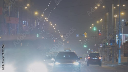 Timelapse footage ofg night traffic with blurred lights of moving vehicles on city street. photo