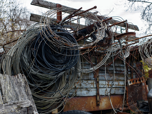 Wires of different kinds are twisted into rings and hang on iron rods