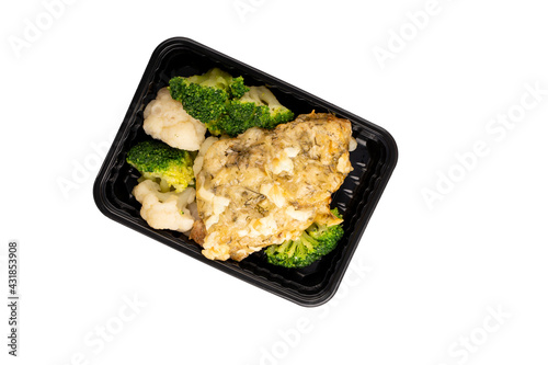 Lunch box with broccoli, cauliflower and chops. Food delivery. Top view. Isolated. Plastic container take away with cooked broccoli, cauliflower and chops