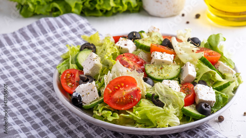 Delicious vegetables salad with feta cheese and olives.
