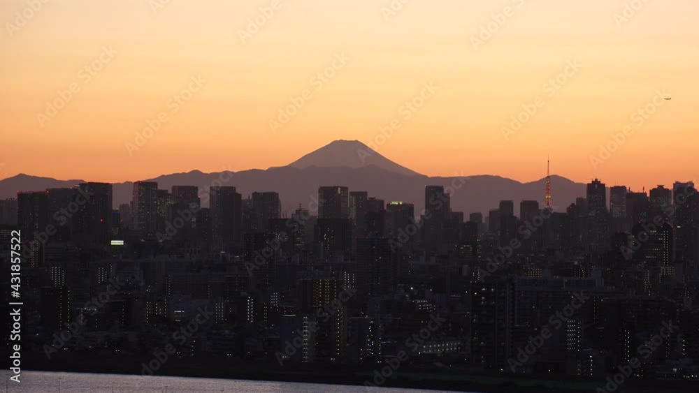 TOKYO, JAPAN : Aerial high angle sunrise or sunset view of CITYSCAPE of TOKYO and MOUNT FUJI. View of buildings at central downtown area. Japanese nature and city life concept. Real time shot. TOKYO, JAPAN : Aerial high angle sunrise or sunset view of CITYSCAPE of TOKYO and MOUNT FUJI. View of buildings at central downtown area. Japanese nature and city life concept. Real time shot.
