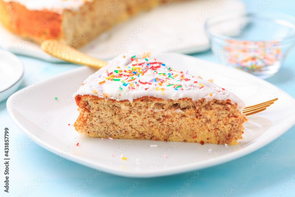 Homemade gluten-free almond case with lemon icing and sugar sprinkles