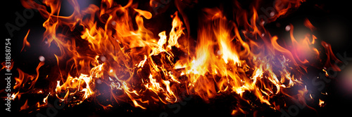Wide Fire flames on black background. fire burst texture for banner backdrop.
