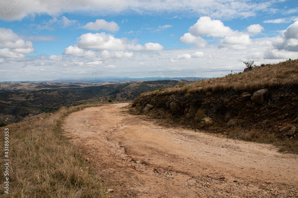 Curved Dirt Road on Hilltop Surrounded by Bleak Landscape