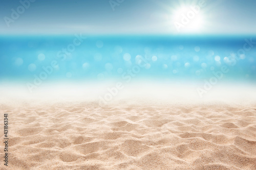 Tropical summer sandy beach focus area and bokeh sun light on blurry sea background Summer time concept background © OHishi_Foto