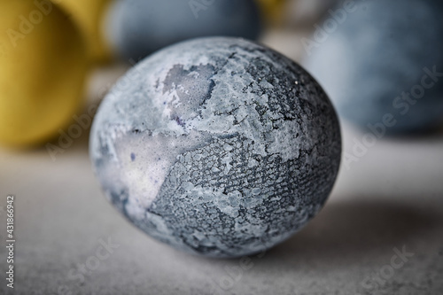 Homemade Easter colored grey marble egg. Macro  selective focus