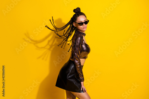 Profile side photo of young black woman serious look gorgeous sunglass isolated over yellow color background
