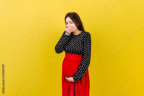 Pregnant woman suffering from toxicosis. Toxicosis Of Pregnancy. Pregnant Lady Feeling Sick Having Nausea Standing On Colored isolated Background. Free Space © sosiukin