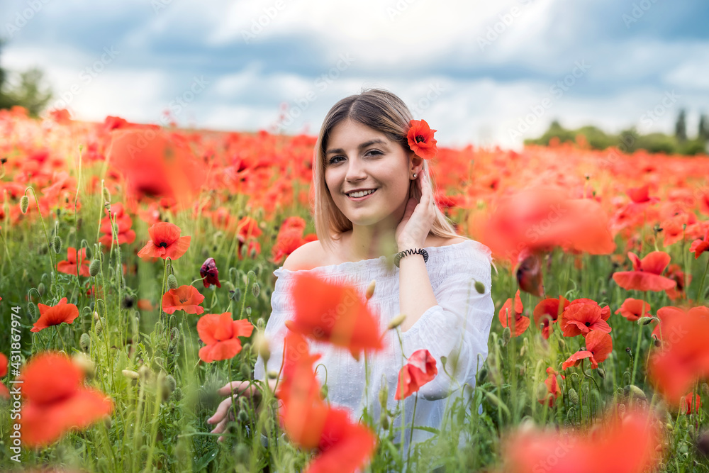 Naklejka premium portrait of beauty and fashion girl in poppy field