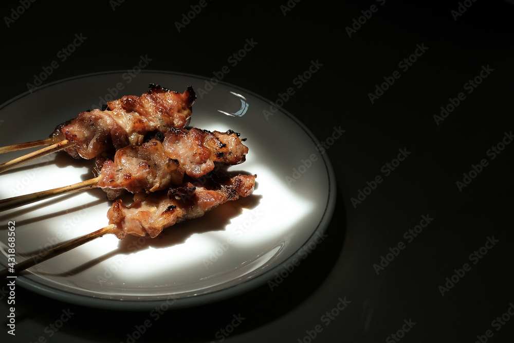 Grilled skewered  pork with sweet sauce, Thai traditional food or Thai street food style