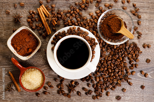 Cup of black coffee with coffee beans.
