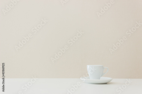 A white cup of coffee on table.