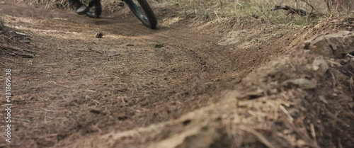 MTB bike wheel brakes on berm or turn wheel tyre soil fly close up