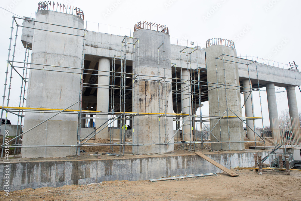 Obraz premium Construction of support columns of a transport bridge, road junction
