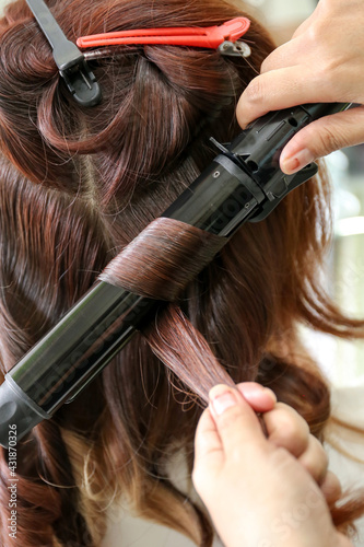 Woman's hair being coloring or painted at the hair stylist beauty salon