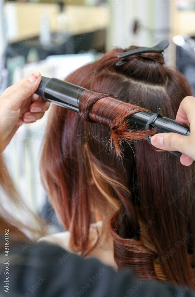 Fototapeta premium Woman's hair being coloring or painted at the hair stylist beauty salon