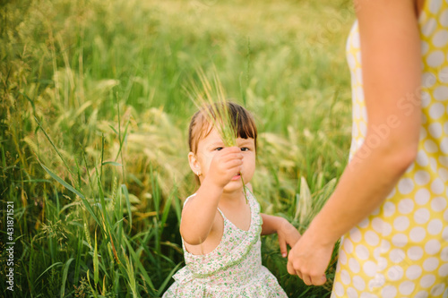 mom and daughter playing in the field.