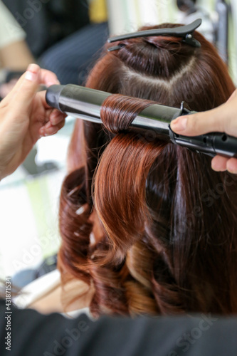 Woman's hair being coloring or painted at the hair stylist beauty salon